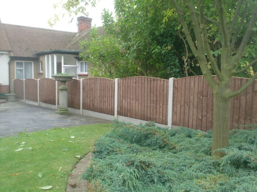Curved-top closeboard garden fence installed by Ryan Fencing in Essex