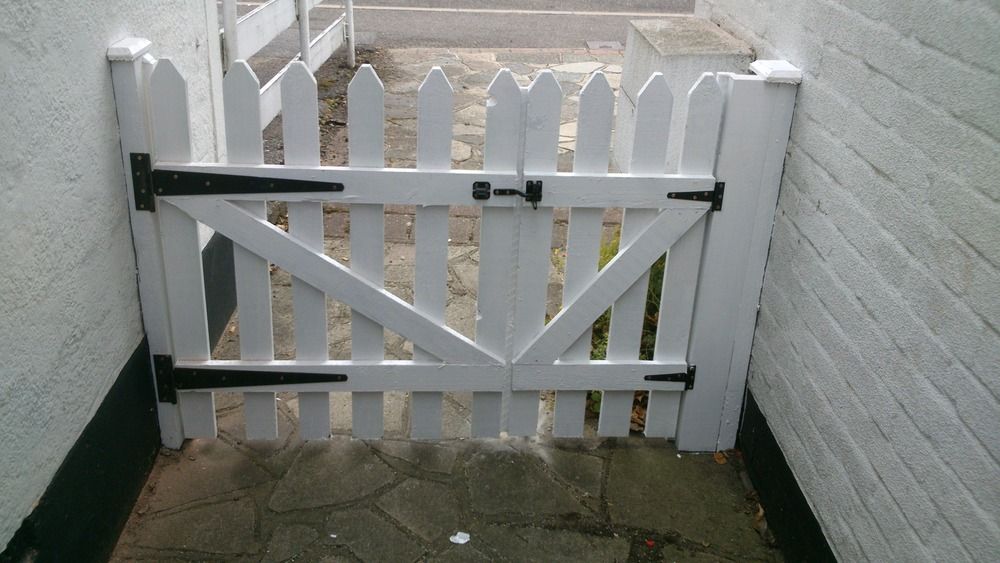 Freshly painted picket gate by Ryan Fencing