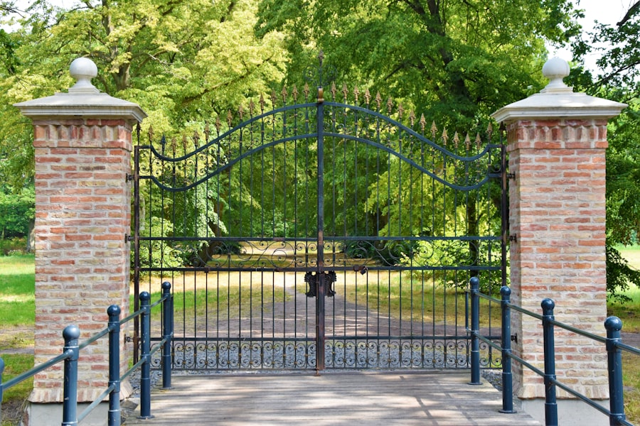 Metal driveway gates between brick pillars